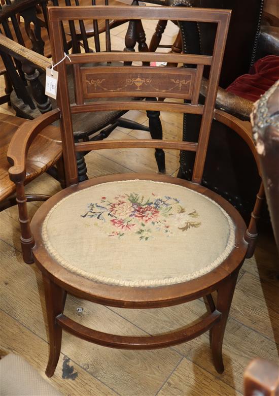 An Edwardian tapestry seat elbow chair